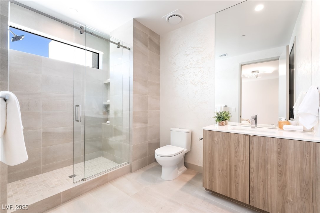 33 Falling Ridge Lane Henderson, NV 89011 - Photo 40 of 70 Bathroom with vanity, a shower stall, and light tile patterned flooring