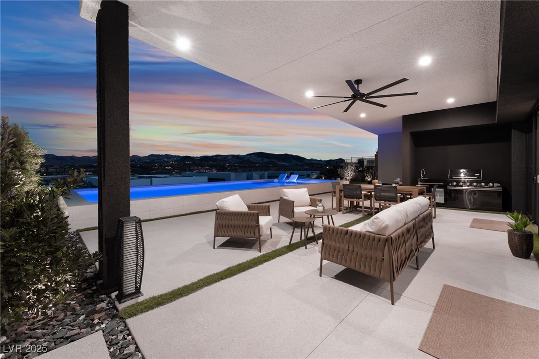 33 Falling Ridge Lane Henderson, NV 89011 - Photo 47 of 70 Patio terrace at dusk featuring a ceiling fan, an outdoor hangout area, outdoor dining area, a patio, and area for grilling