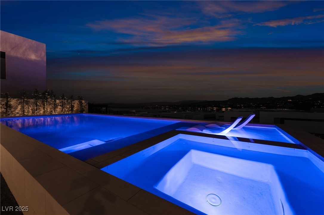 33 Falling Ridge Lane Henderson, NV 89011 - Photo 48 of 70 View of pool featuring an in-ground hot tub, a patio, and an infinity pool
