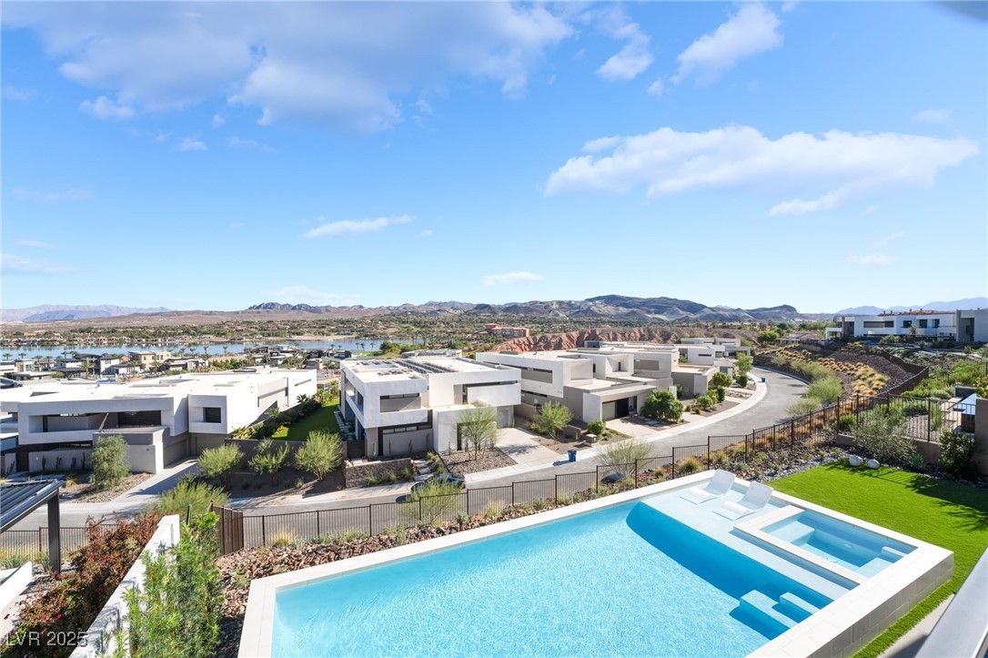 33 Falling Ridge Lane Henderson, NV 89011 - Photo 5 of 70 View of swimming pool featuring a mountain view, a patio, a residential view, and a pool with connected hot tub