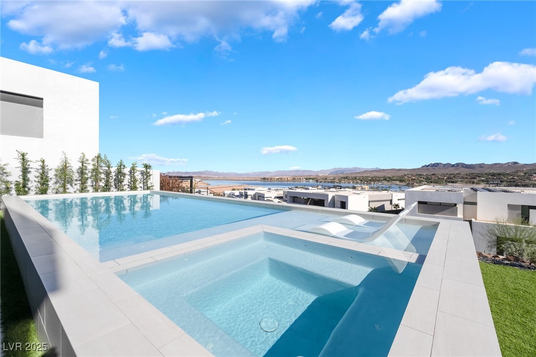 33 Falling Ridge Lane Henderson, NV 89011 - Photo 6 of 70 View of swimming pool featuring a patio area, an in-ground hot tub, an infinity pool, and a mountain view
