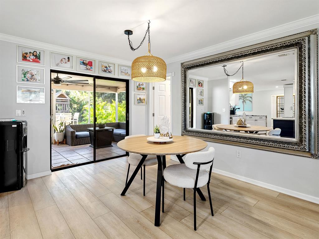 6502 Bikini Way Sarasota, FL 34241 - Photo 14 of 43 a view of a dining room with furniture window and wooden floor