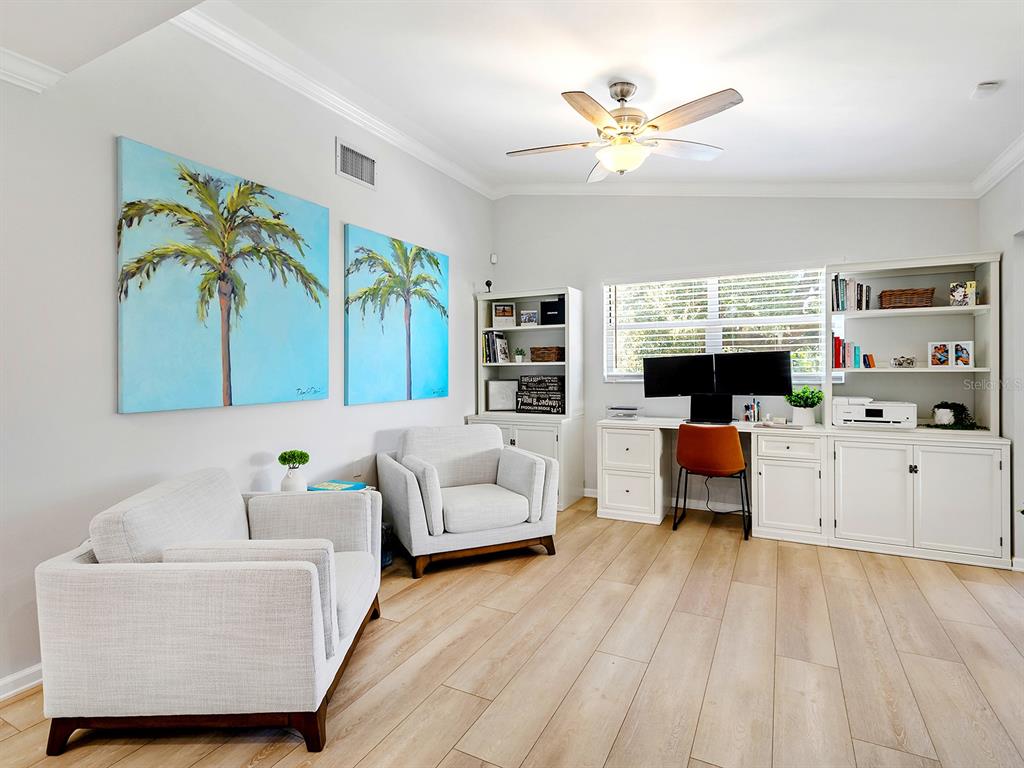 6502 Bikini Way Sarasota, FL 34241 - Photo 17 of 43 a living room with furniture and a large window with potted plants