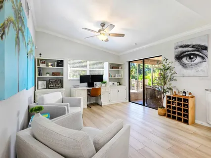 a living room with furniture and a floor to ceiling window