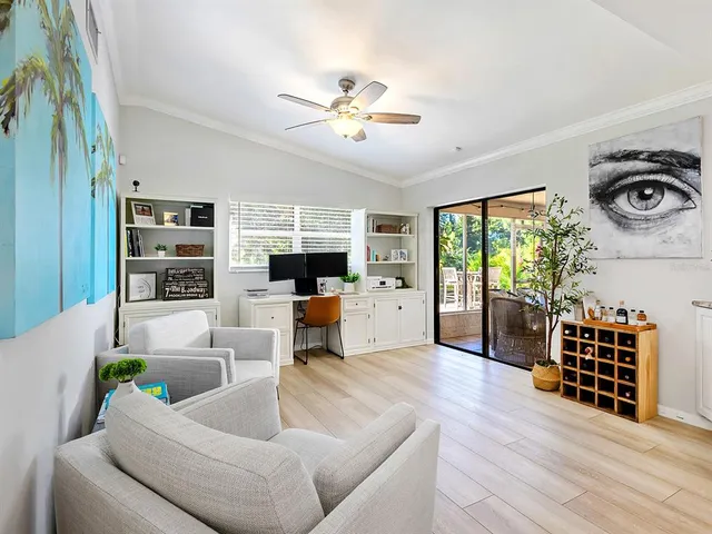 a living room with furniture and a floor to ceiling window