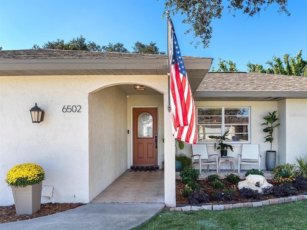 6502 Bikini Way Sarasota, FL 34241 - Photo 2 of 43 a front view of a house with a yard