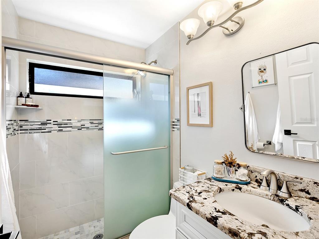 6502 Bikini Way Sarasota, FL 34241 - Photo 21 of 43 a bathroom with a sink toilet and shower