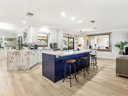 a room with a wooden cabinets and dining table