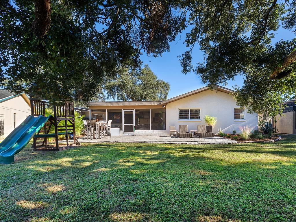 6502 Bikini Way Sarasota, FL 34241 - Photo 36 of 43 a front view of house with a garden and trees