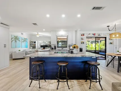 a kitchen with granite countertop a table and chairs in it