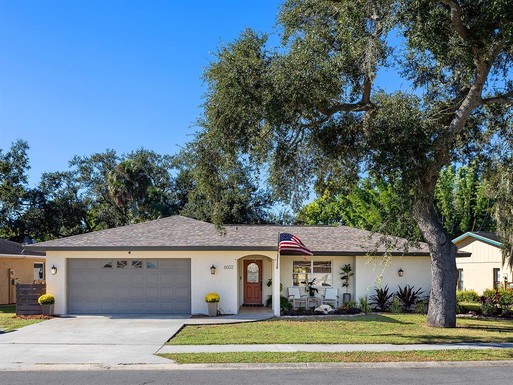 6502 Bikini Way Sarasota, FL 34241 - Photo 42 of 43 a front view of a house with a garden