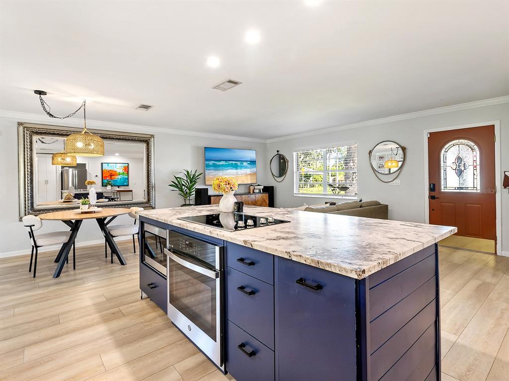 6502 Bikini Way Sarasota, FL 34241 - Photo 7 of 43 a kitchen with a stove a sink a dining table and chairs
