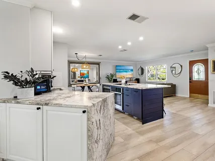 a kitchen with stainless steel appliances kitchen island granite countertop a sink and cabinets