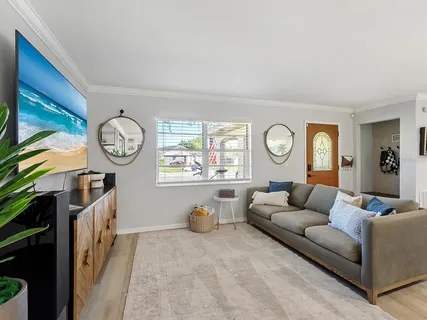 a living room with furniture a clock and a window