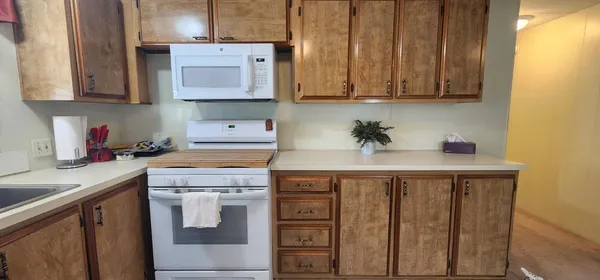 a kitchen with stainless steel appliances cabinets and a counter top space