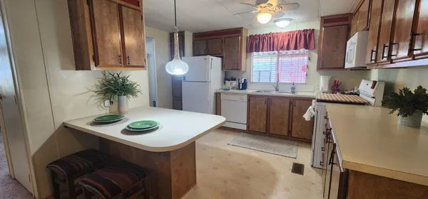 a kitchen with a sink a stove and chairs