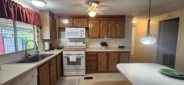 a kitchen with a sink cabinets and window