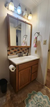 a bathroom with a sink vanity and mirror