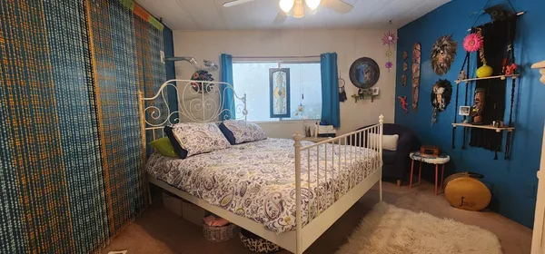 a bedroom with bed and cabinets
