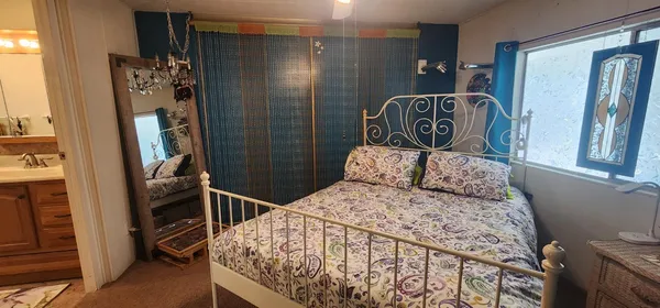 a bedroom with a bed and a mirror