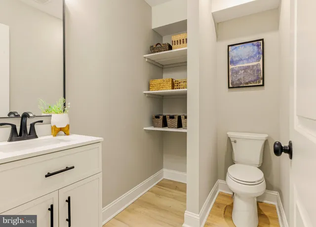 a bathroom with a toilet sink and mirror