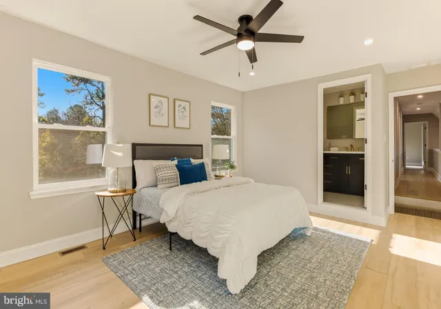 a large bedroom with a bed and a painting on the wall