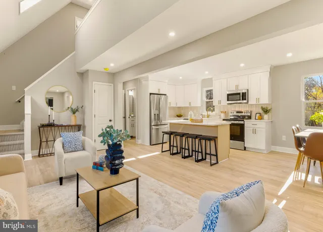 a living room with kitchen island furniture and a kitchen view