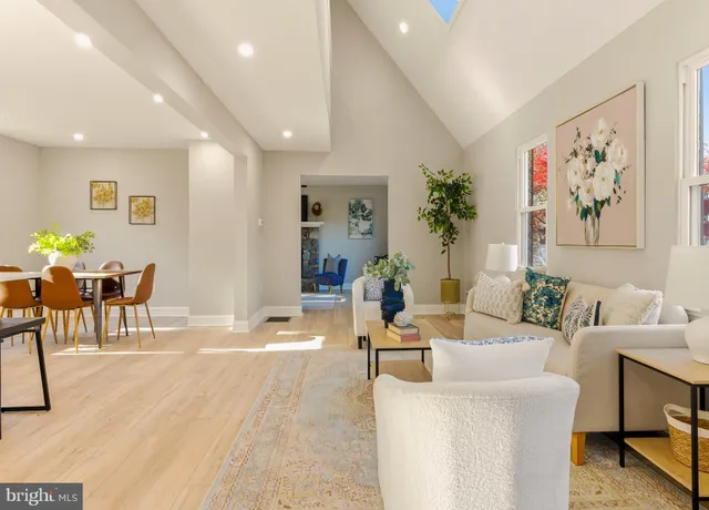 a living room with furniture and a painting on the wall