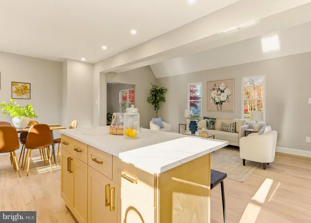 a living room with kitchen island furniture and a table