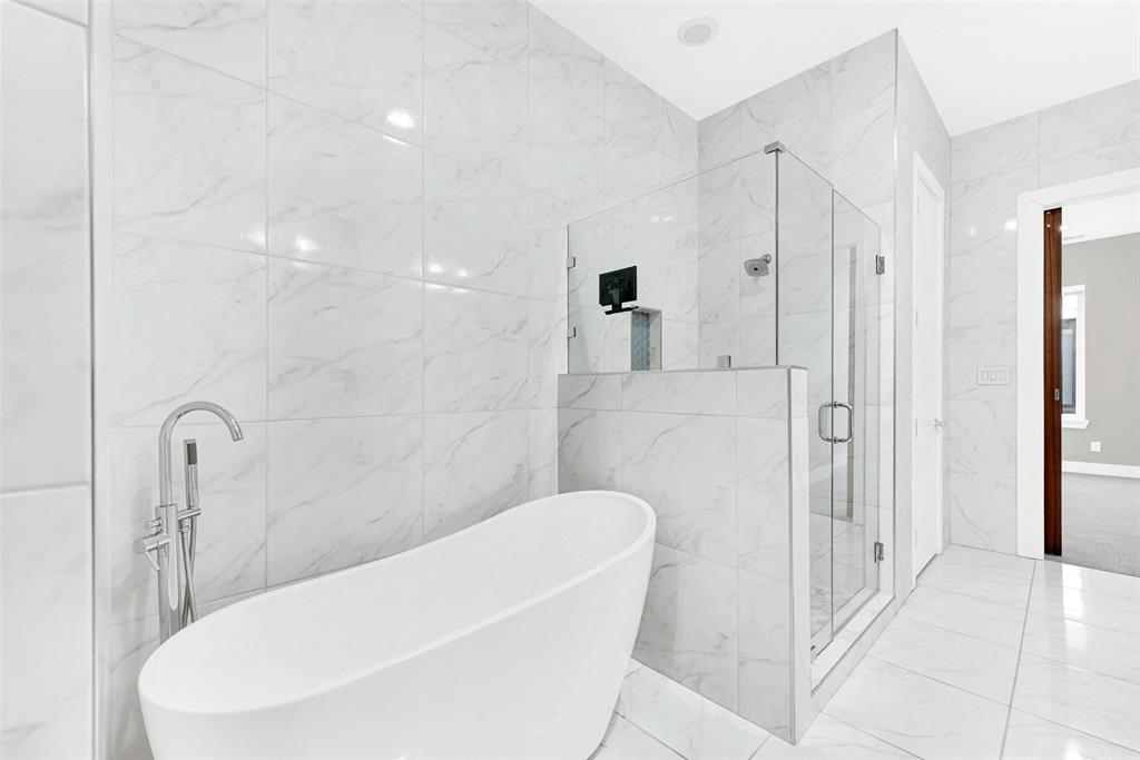 4060 Spring Valley Road, Unit 105 Farmers Branch, TX 75244 - Photo 13 of 19 a bathroom with a bathtub and a shower
