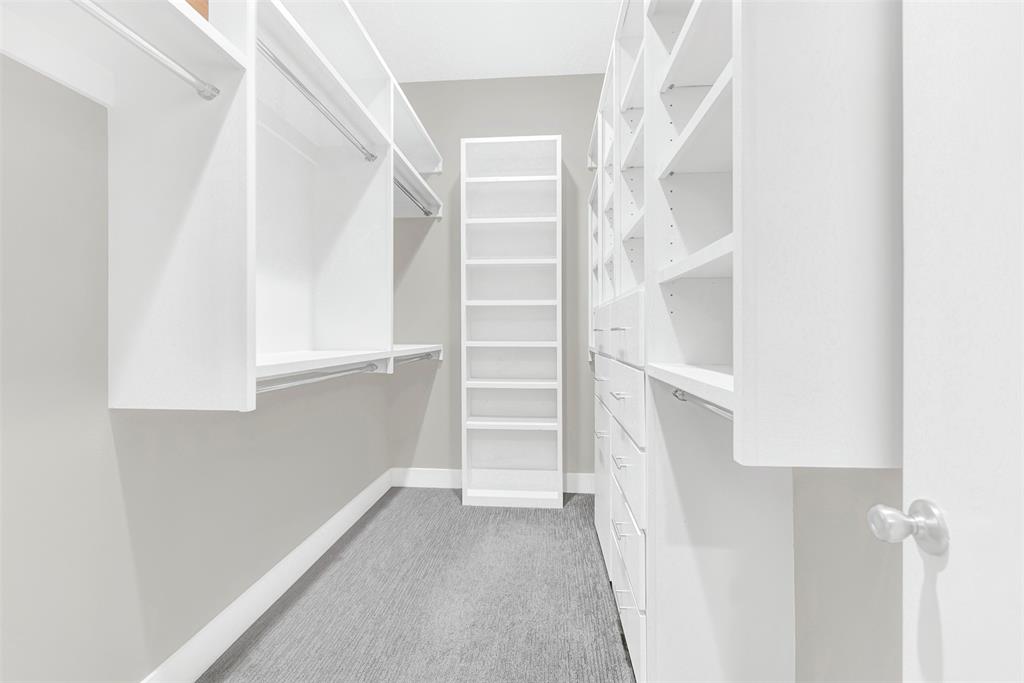 4060 Spring Valley Road, Unit 105 Farmers Branch, TX 75244 - Photo 14 of 19 a view of walk in closet with empty racks