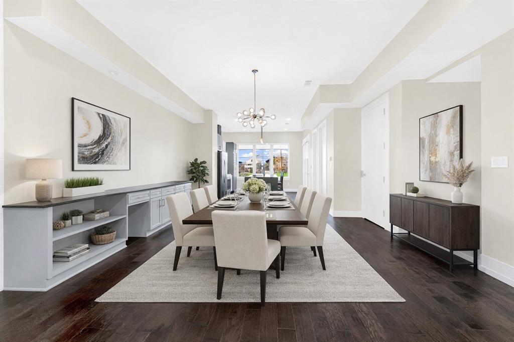 4060 Spring Valley Road, Unit 105 Farmers Branch, TX 75244 - Photo 3 of 19 a living room with furniture a rug and a chandelier