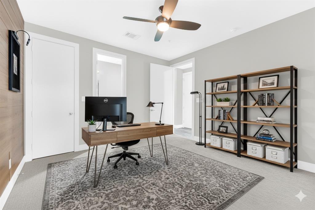 4060 Spring Valley Road, Unit 105 Farmers Branch, TX 75244 - Photo 4 of 19 a work room with furniture and wooden floor