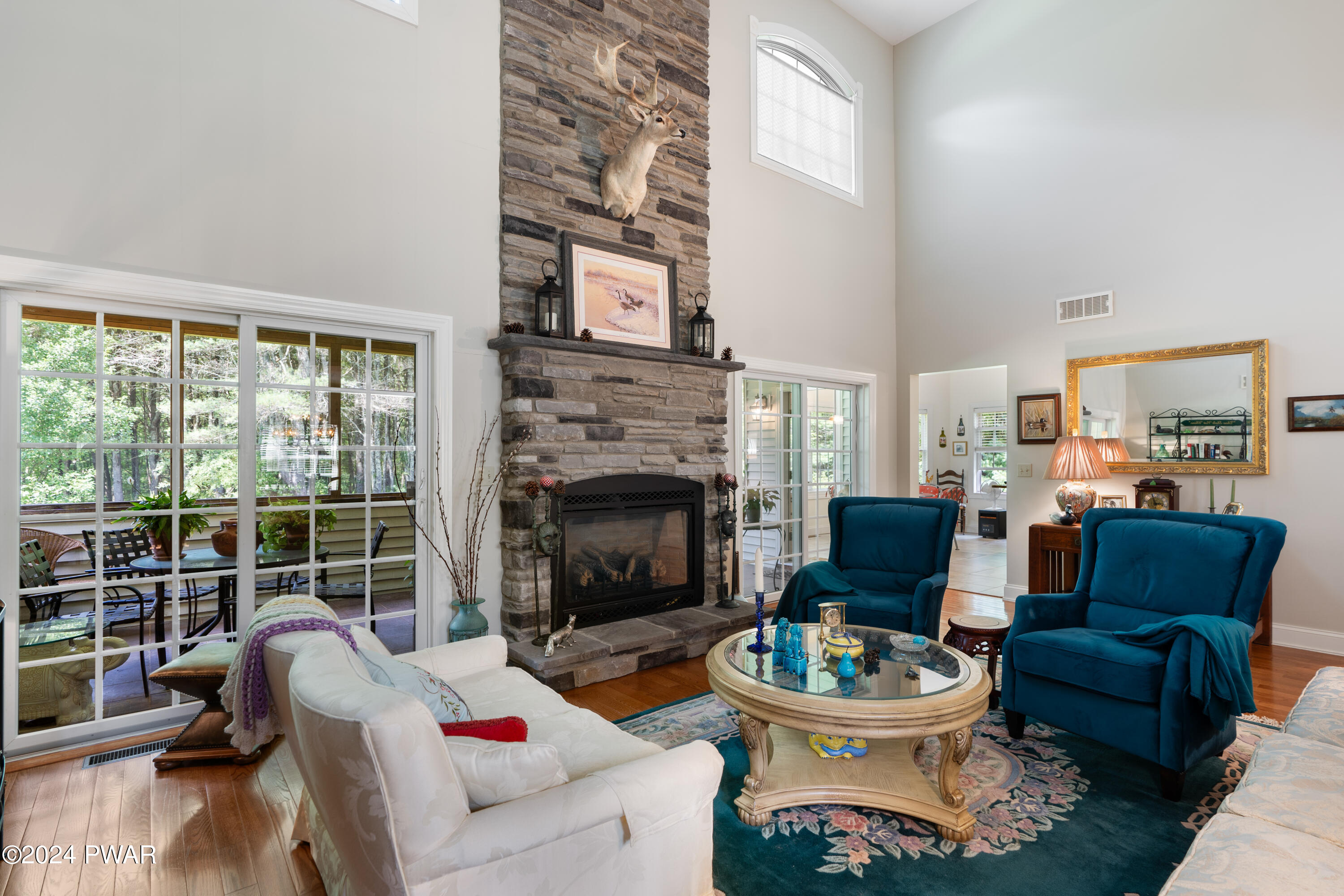 208 Long Meadow Road Milford, PA 18337 - Photo 10 of 64 a living room with furniture a fireplace and a large window