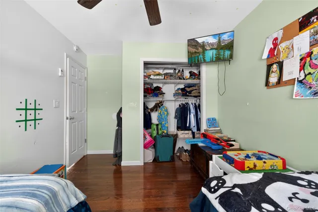 a bedroom with furniture and a wooden floor