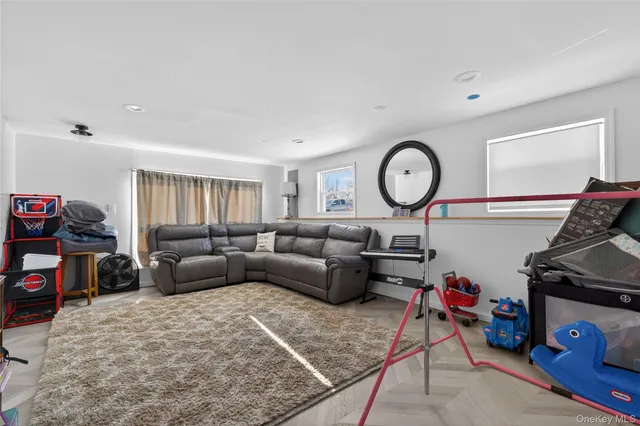 a living room with furniture a rug and a window