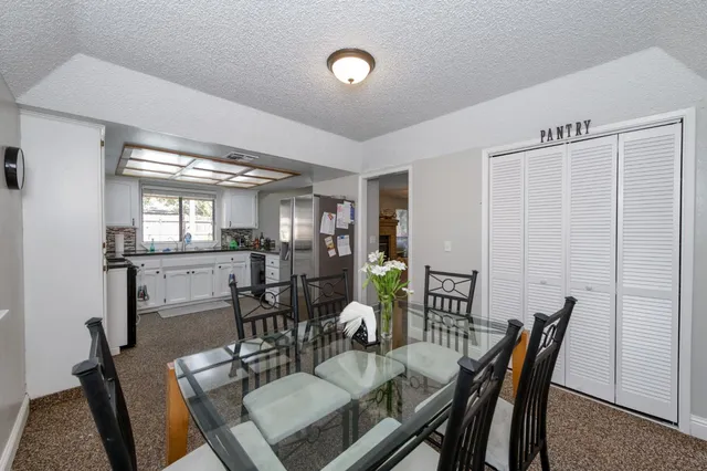 a dining room with furniture and window