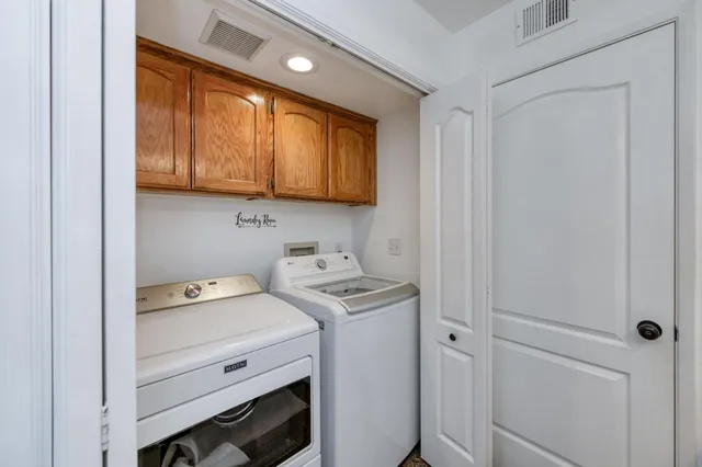 a utility room with sink dryer and washer