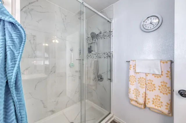 a bathroom with a shower and a mirror