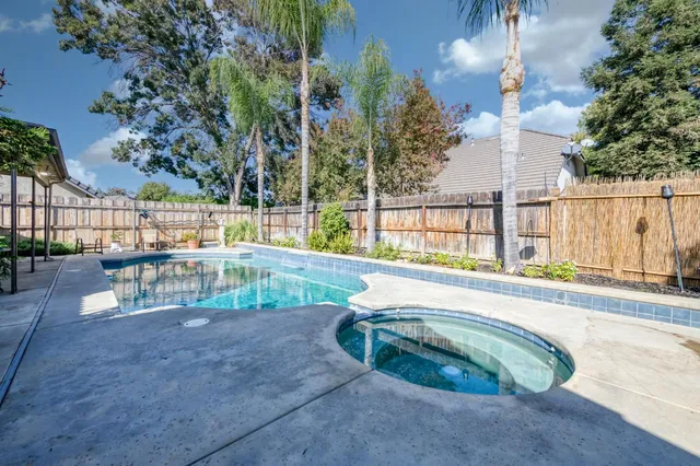 a view of swimming pool with a patio