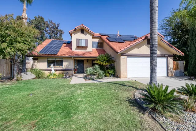 a front view of a house with a garden and porch