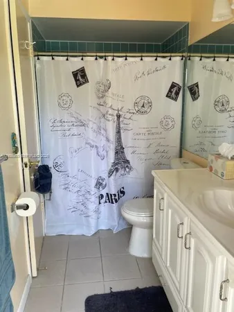 a bathroom with a toilet sink and shower