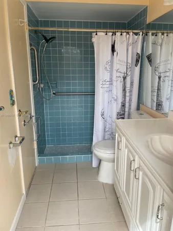 a bathroom with a shower toilet and sink