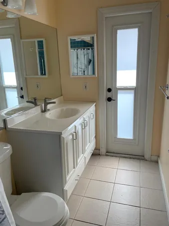 a bathroom with a sink a toilet and mirror