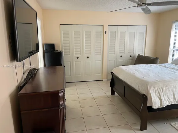 a bedroom with a bed and a flat screen tv