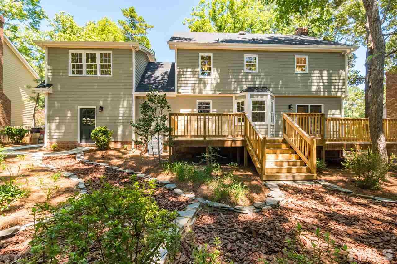 7405 Wilderness Road Raleigh, NC 27613 - Photo 22 of 25 front view of a house with a yard