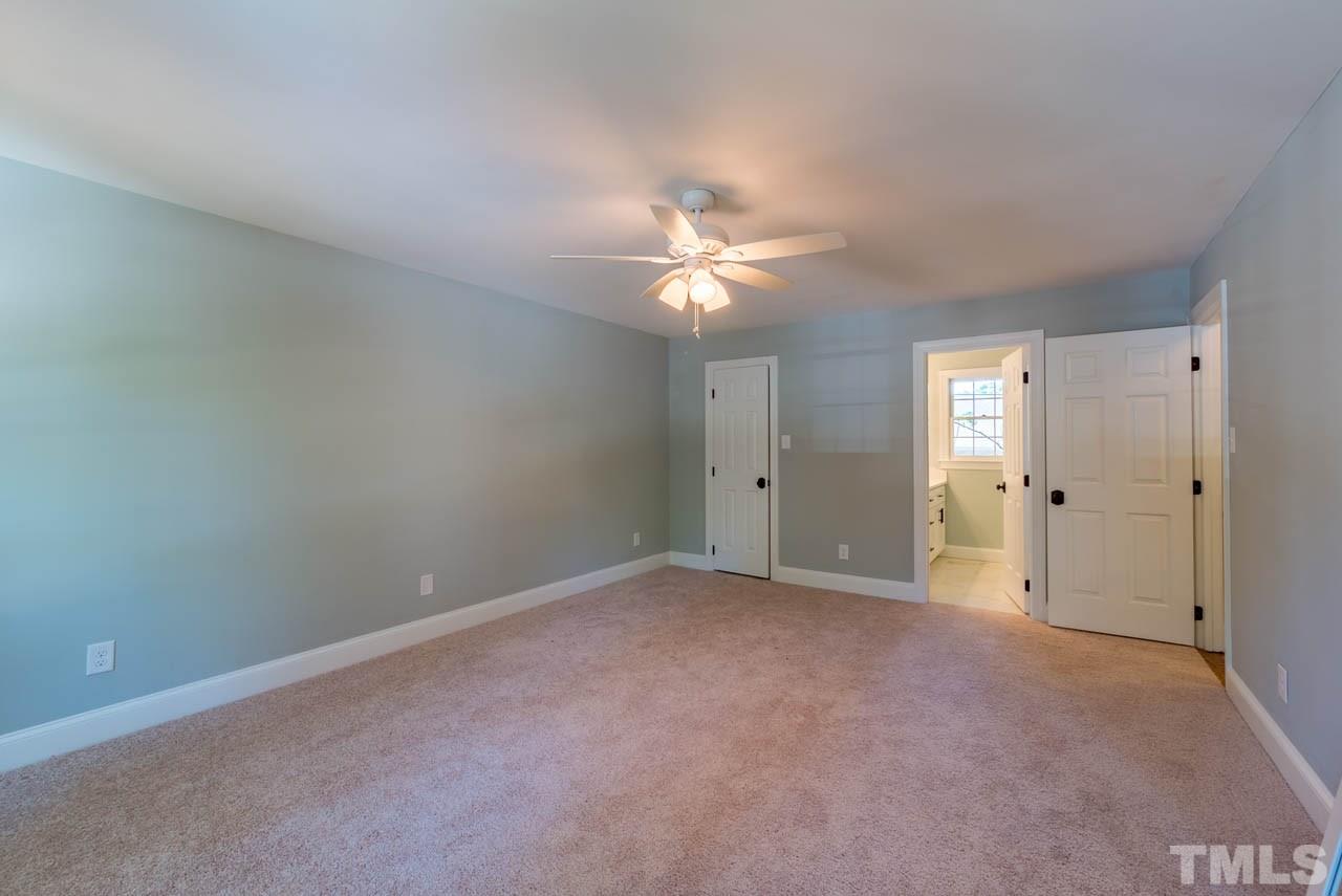 7405 Wilderness Road Raleigh, NC 27613 - Photo 8 of 25 a view of an empty room with a ceiling fan
