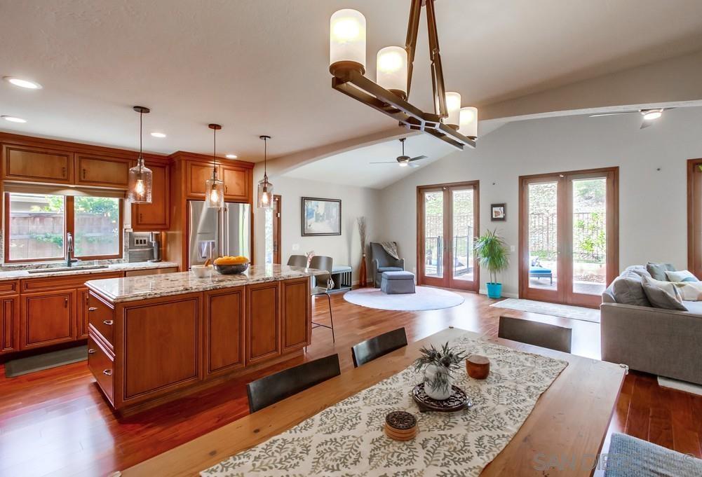 12128 Eagle Street San Diego, CA 92131 - Photo 11 of 37 a living room with furniture a chandelier and a dining table