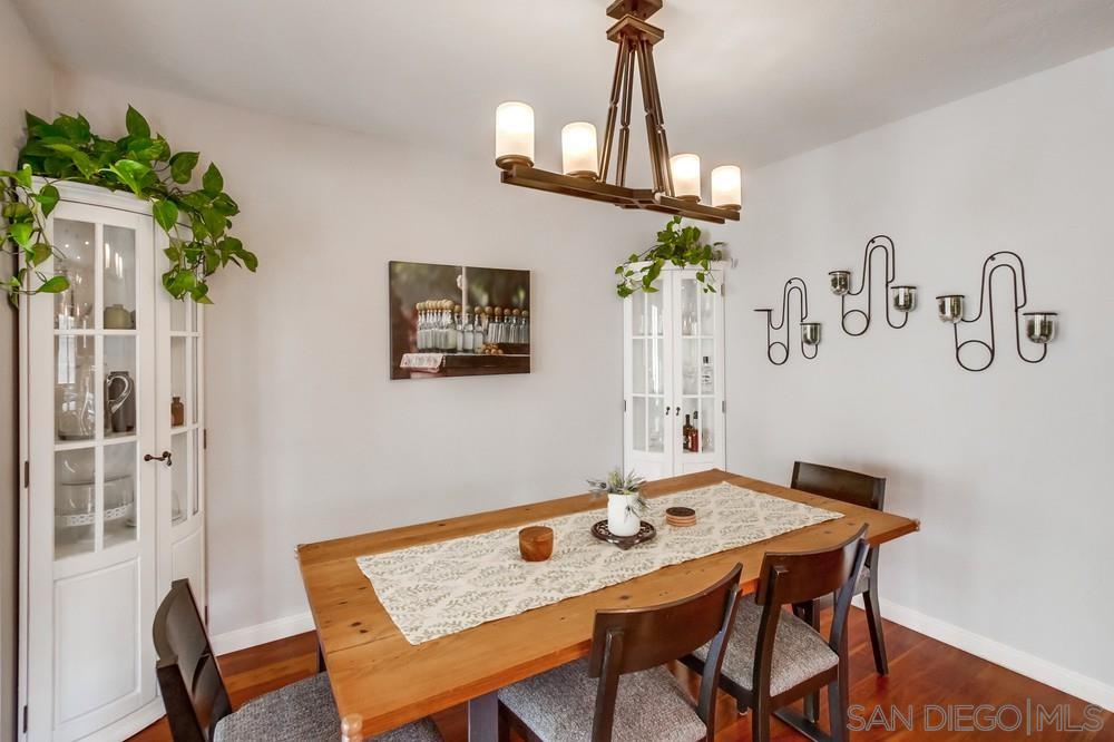 12128 Eagle Street San Diego, CA 92131 - Photo 12 of 37 a view of a dining room with furniture and chandelier