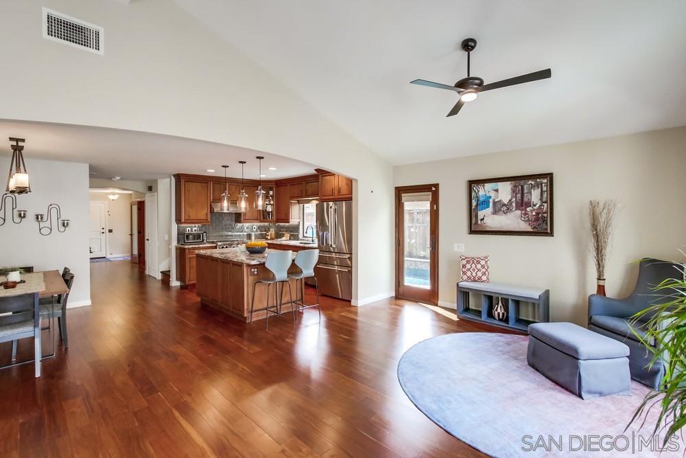 12128 Eagle Street San Diego, CA 92131 - Photo 13 of 37 a living room with fireplace furniture and a wooden floor